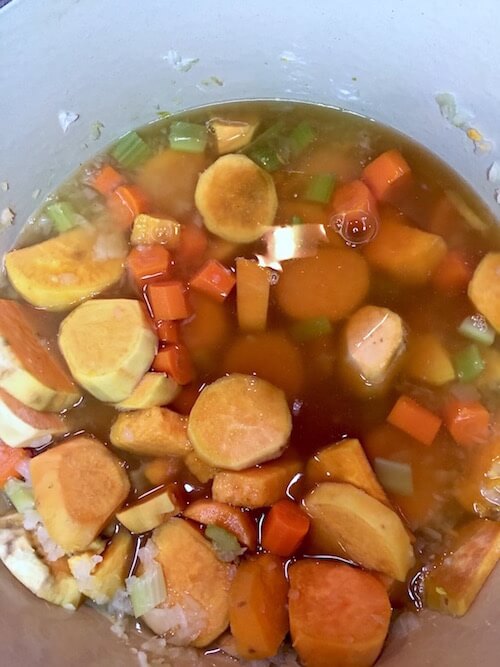 Sweet Potatoes, onion, celery in a pot with vegetable broth|Ginger Sweet Potato Soup | The Radiant Root