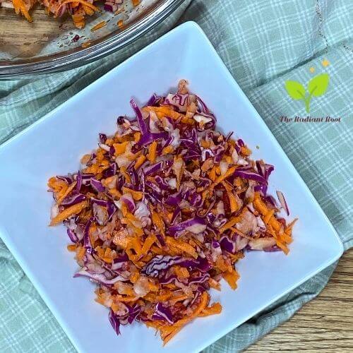 Bowl of coleslaw with raspberries, red cabbage, carrots, and zucchini shreds | The Radiant Root