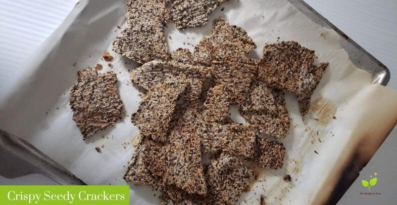 Crispy Seedy Crackers on a baking sheet with parchment paper | The Radiant Root