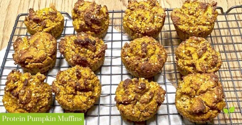 A cooling rack with protein pumpkin muffins over a white dish towel | The Radiant Root