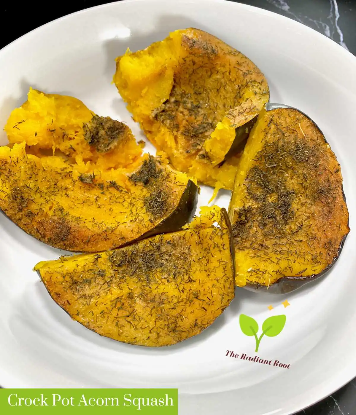 A white bowl on a grey slab background with seasoned acorn squash cut into quarters. With the words in green and white writing "Crock Pot Acorn Squash" | Crock Pot Acorn Squash | The Radiant Root