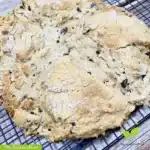 Loaf of baked Gluten-Free Irish Soda Bread on a wire rack with the words "The Radiant Root." | Gluten-Free Irish Soda Bread | The Radiant Root