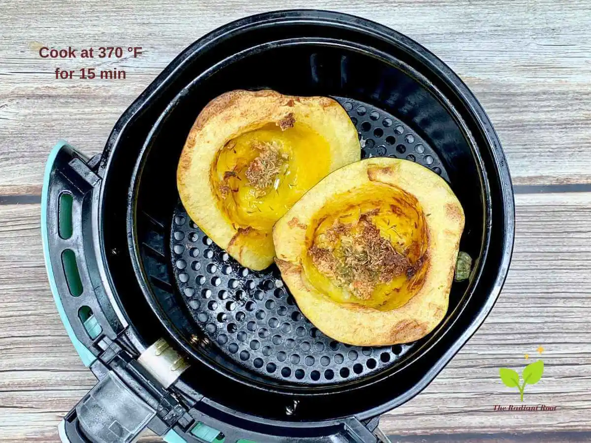 Recipe Instruction Photos 7 of 8: A wooden table with air fried veggie in air fryer basket. In the top left hand corner it reads “Cook at 370 °F for 15 min” | acorn squash healthy recipes | The Radiant Root