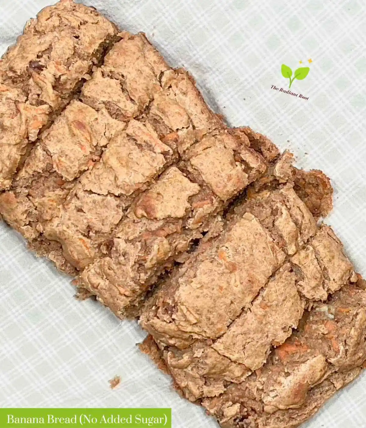 Cooked banana bread on a white kitchen towel with the words "Banana bread (no added sugar) in green and white lettering | Banana Bread No Added Sugar Recipe | The Radiant Root