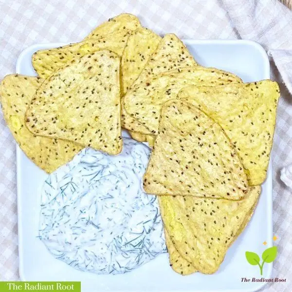 Vegan Dill Dip on a white plate with gluten-free chips and a checkered brown and white towel | homemade dill dip | The Radiant Root