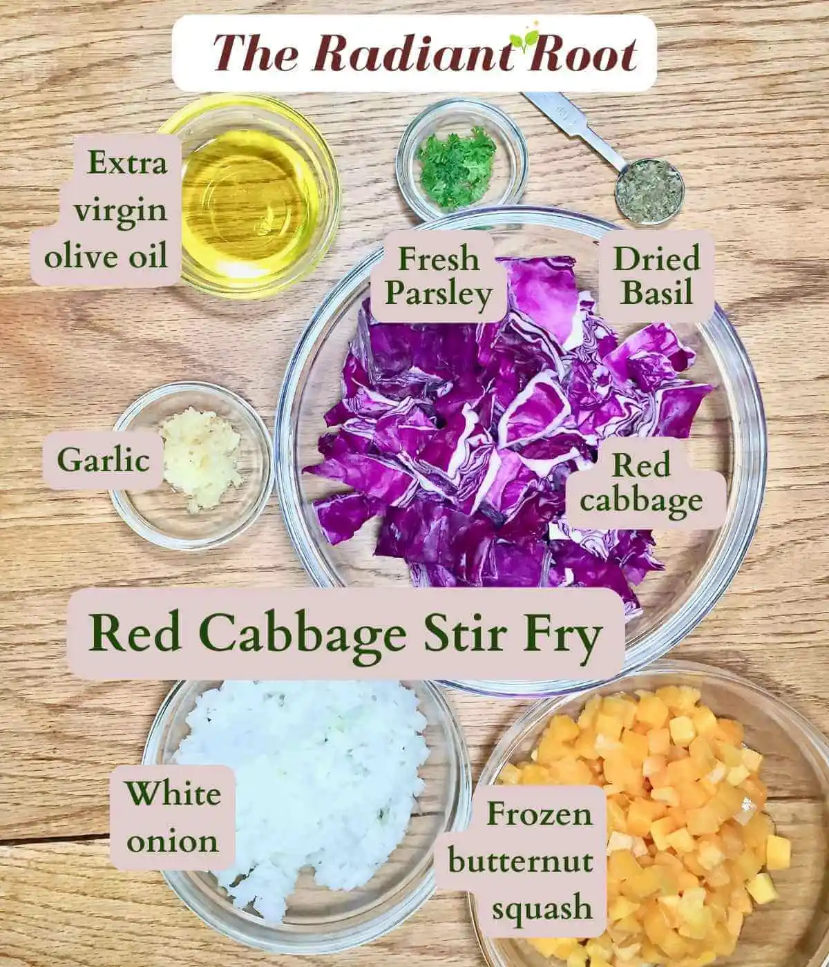 Red Cabbage Stir Fry ingredient photo: At the top it reads “The Radiant Root” below is a wooden table with clear glass bowls of various sizes containing the ingredients for this recipe: extra virgin olive oil, parsley, basil, garlic, red cabbage, white onion, and butternut squash. Next to each ingredient reads its name. It also reads “Red Cabbage Stir Fry.” | stir fried purple cabbage | The Radiant Root