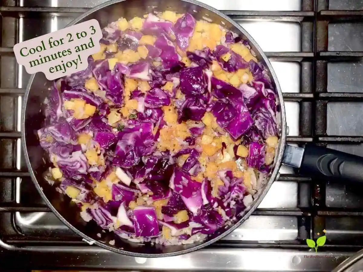 Red Cabbage Stir Fry recipe instruction photo 14 of 14 : A close up of the pan containing the cooked white diced onion, garlic, red cabbage, olive oil, parsley, basil, and butternut squash mixed together finished on a stove top. It reads “cool for 2 to 3 minutes an enjoy!” | best way to cook cabbage | The Radiant Root