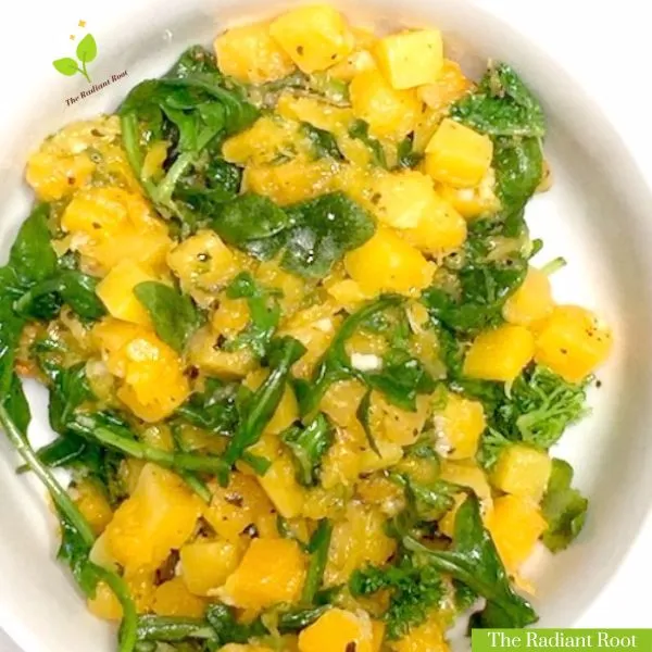 Sauteed butternut squash main photo shows a close up of a white bowl containing the finished butternut squash and arugula saute. Below in the left right corner it reads “The Radiant Root.” | butternut squash stovetop | The Radiant Root