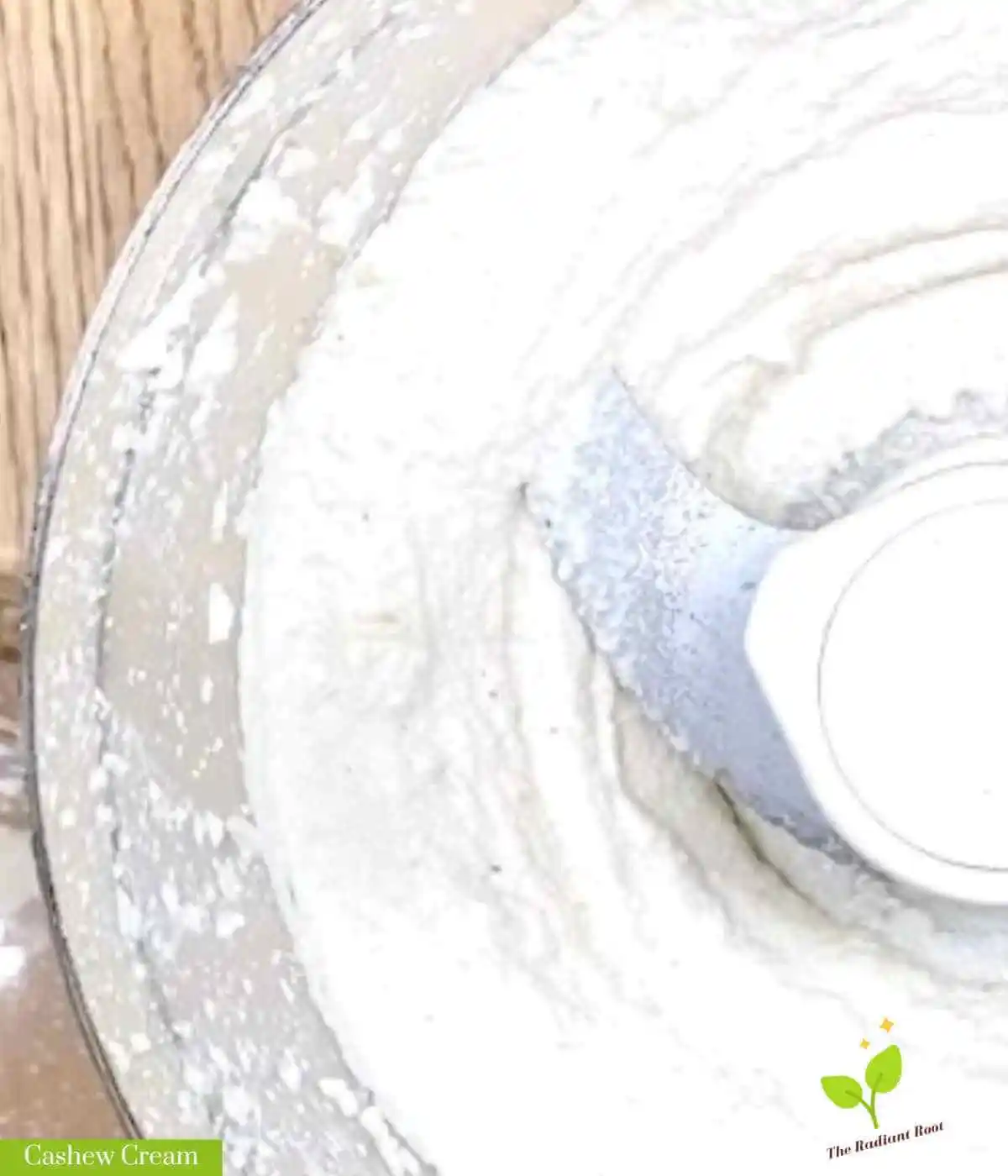 Cashew Cream mail photo: A close up image of a finished cashew cream in a food processor bowl with the words “cashew cream” in the bottom left corner. | cashew sauce recipe | The Radiant Root