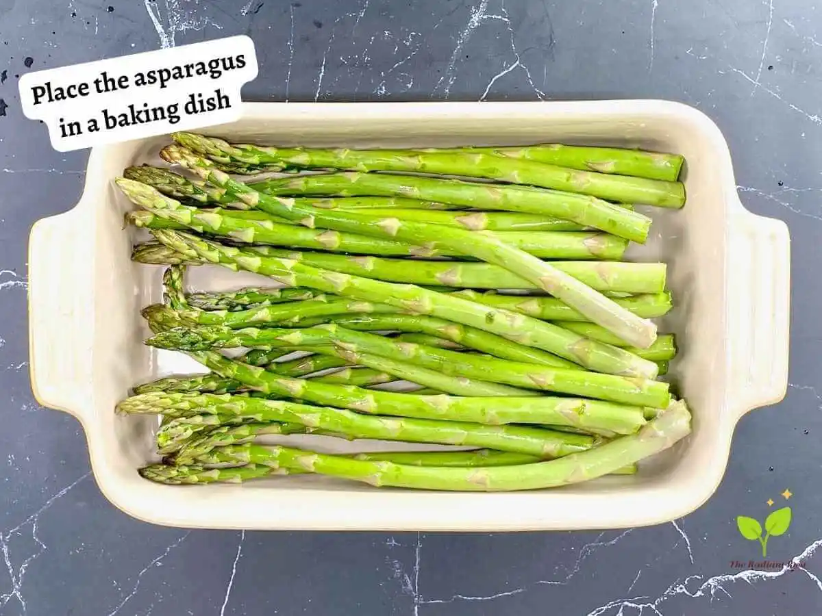 Asparagus with Shallots 9 of 12 : A black marble counter top with a baking dish 7 x 10 inches containing the raw asparagus. It reads “place the asparagus in a baking dish.” | asparagus recipe | The Radiant Root