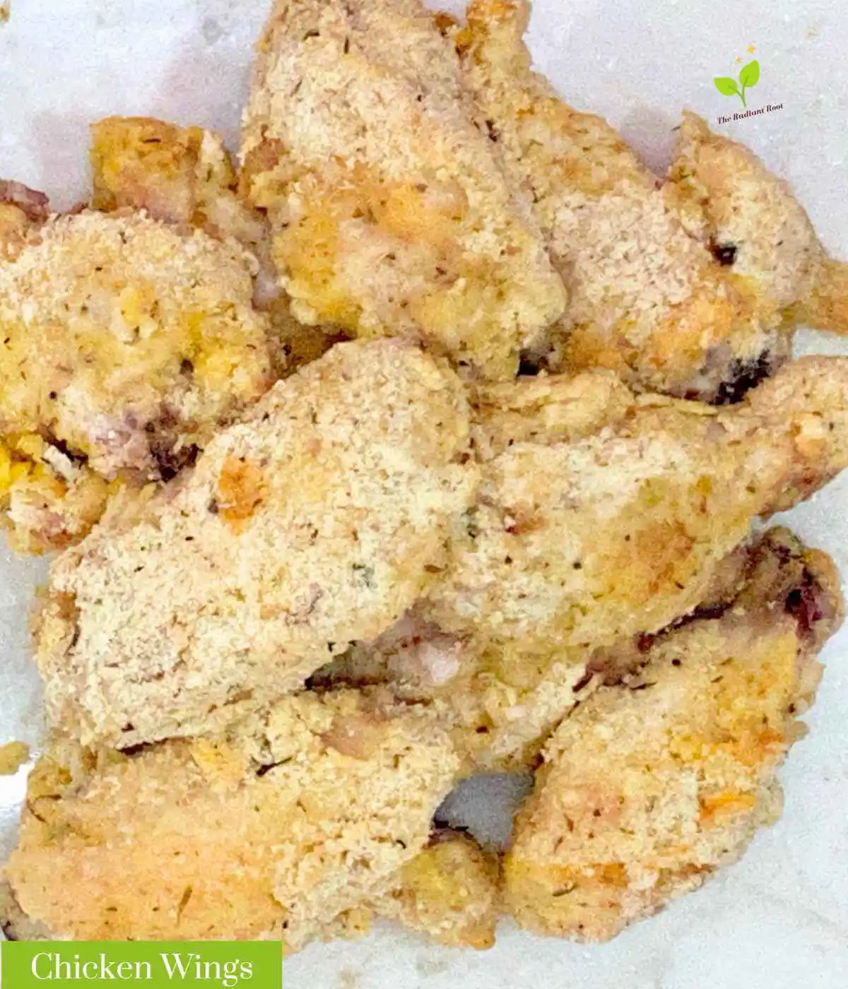 GF Chicken Wings: A close up of finished gluten free chicken wings on a white marble table. In the bottom left corner it reads “Chicken Wings.”| Gluten Free chicken wings | The Radiant Root