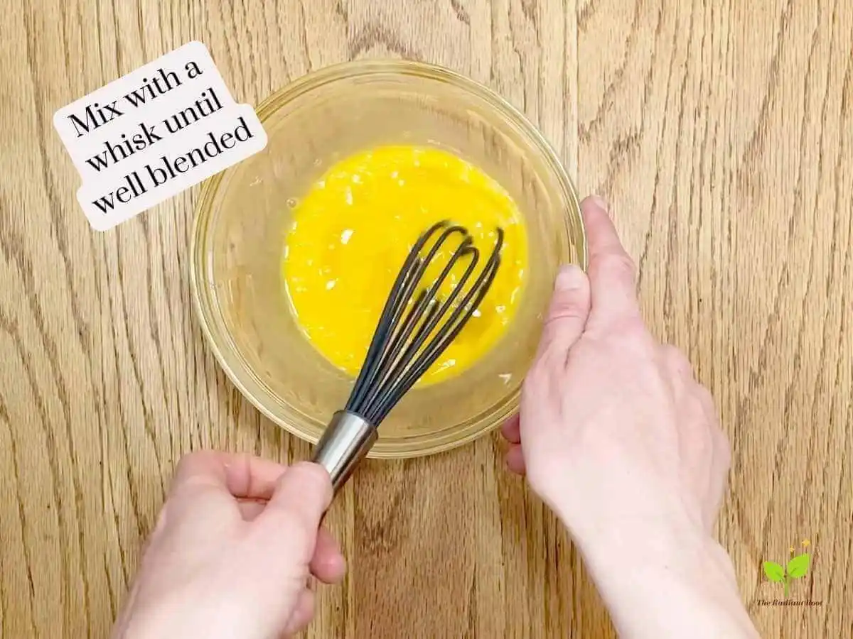 GF Chicken Wings recipe instruction photo 3 of 14 : A wooden table containing a medium mixing bowl with two scrambled eggs. It reads “mix with a whisk until well blended.” | Are chicken wings healthy? | The Radiant Root