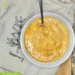 Ginger sweet potato soup in a white bowl with a silver spoon | The Radiant Root